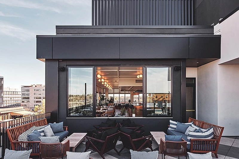 Modern rooftop lounge with outdoor seating area.