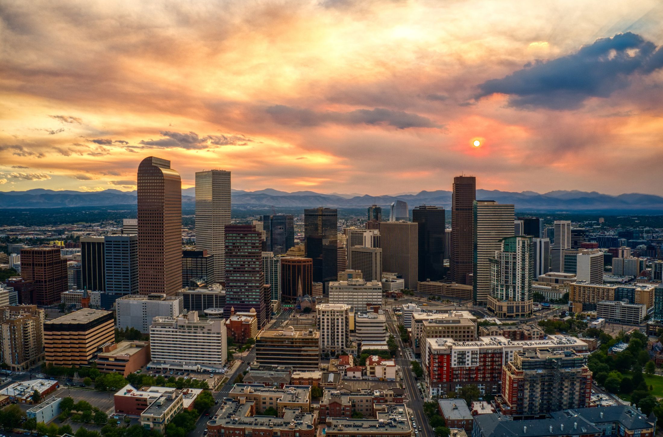City skyline with clouds and reflections.